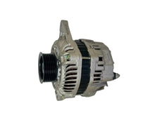 A automotive alternator with a ribbed silver metal housing, black belt cover, and black pulley, resting on a white workbench.