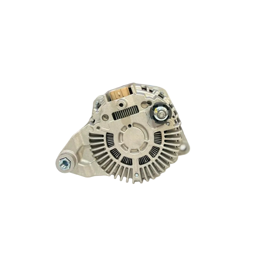 A silver automotive alternator resting on a white surface, with a blurred warehouse or auto parts store background.