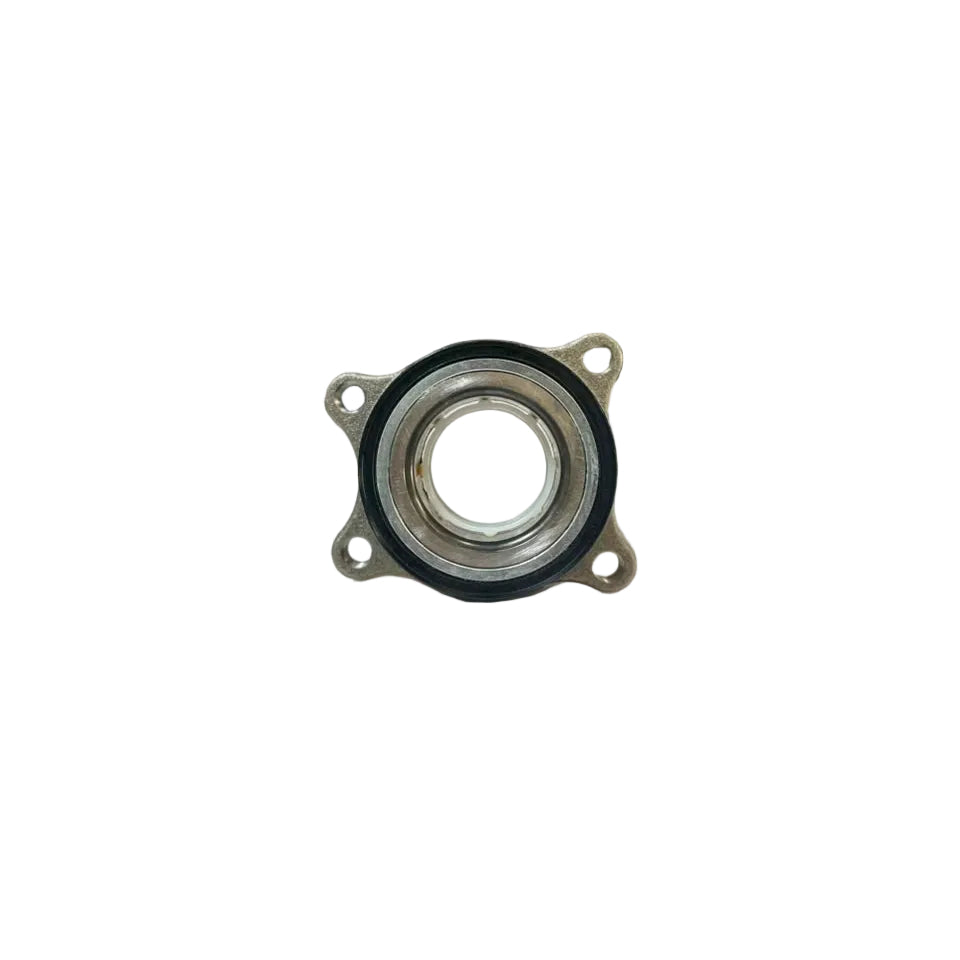 A small metal mechanical bearing or hub component with a black rubber gasket, resting on a white surface with a blurred warehouse background.